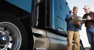 Truck Driving School In US for Foreigners - two man standing on truck side