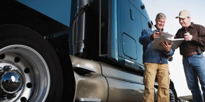 Truck Driving School In US for Foreigners - two man standing on truck side