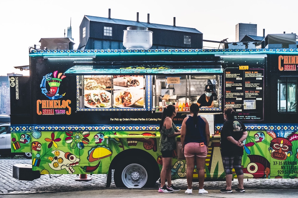 Food truck with three woman consumer