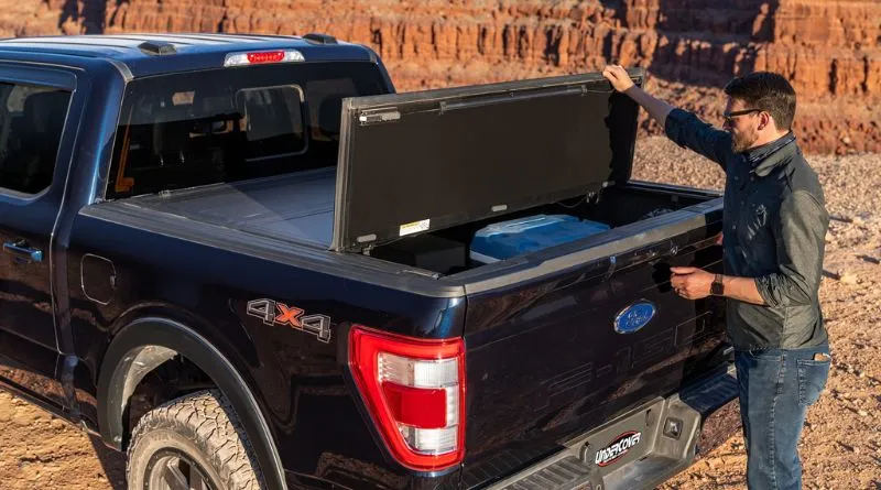 truck driver opens folding bed tonneau covers